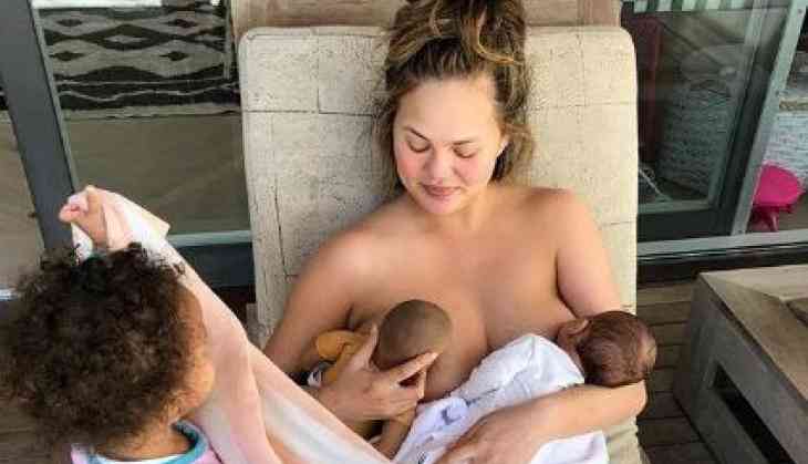 Chrissy Teigen shares topless photo of herself breastfeeding her son Miles and daughter Luna’s doll